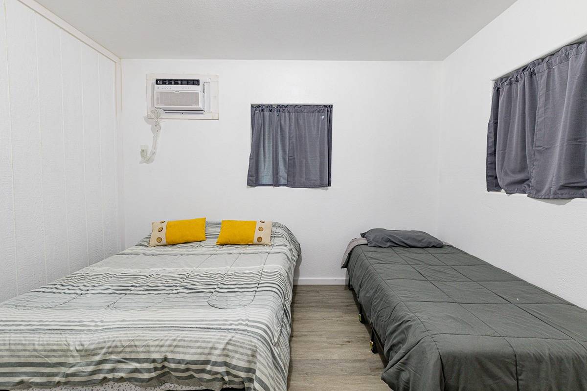 681 Hoaka Road Hilo, HI 96720 - Photo 8 of 26 a bedroom with a bed and painting on the wall