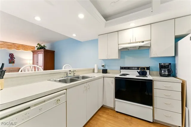a kitchen with a sink stove and cabinets