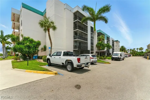 a view of a house with a yard and potted plants