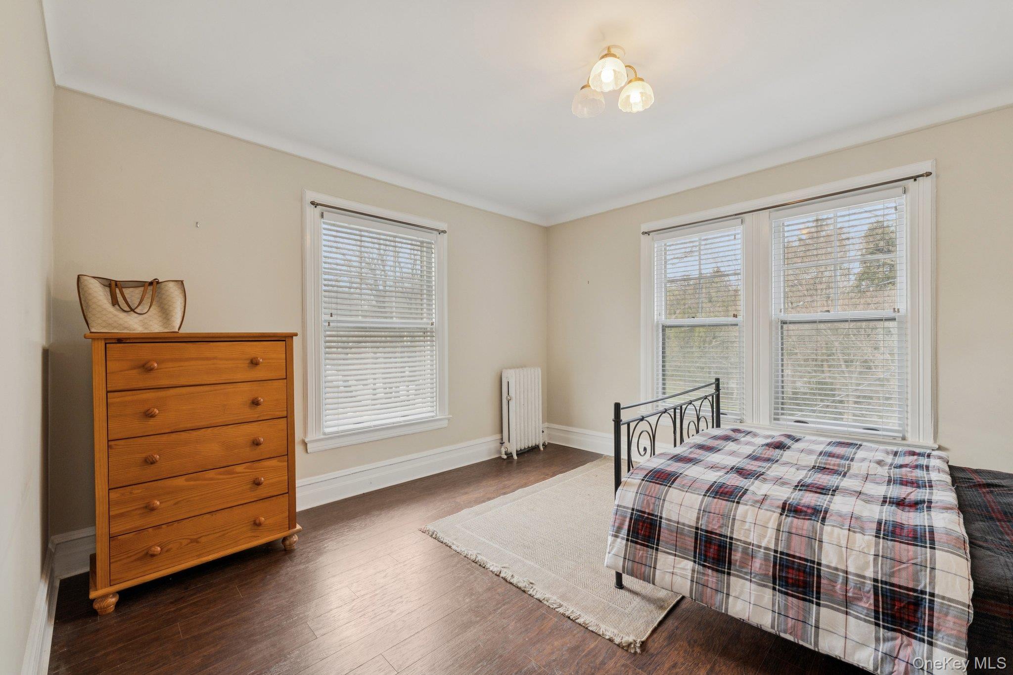 397 Split Rock Road Syosset, NY 11791 - Photo 20 of 29 a bedroom with a bed and wooden floor