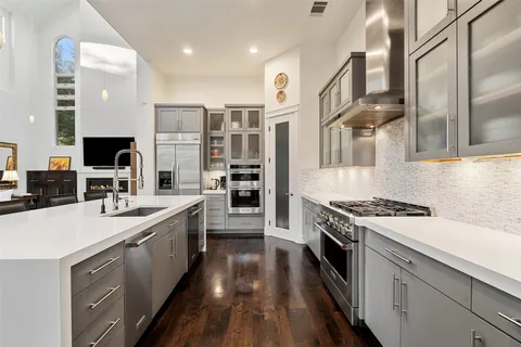 a dining room with stainless steel appliances kitchen island granite countertop a table and chairs