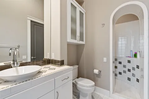 a room with furniture pool table flat screen tv and windows