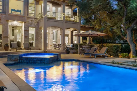 a swimming pool view with a outdoor seating