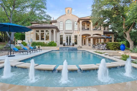 a front view of a house with swimming pool having outdoor seating