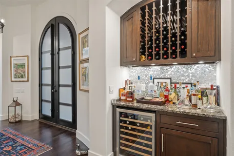 a living room with furniture a fireplace and a chandelier