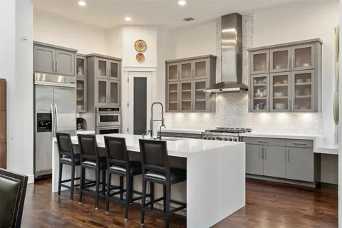 a kitchen with stainless steel appliances granite countertop a stove and a sink