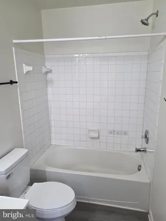 a bathroom with a toilet and a bathtub
