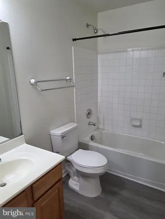 a white toilet sitting next to a bath tub