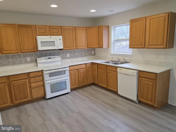 a kitchen with sink cabinets and wooden floor