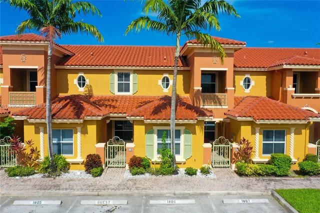 a front view of a residential apartment building with a yard