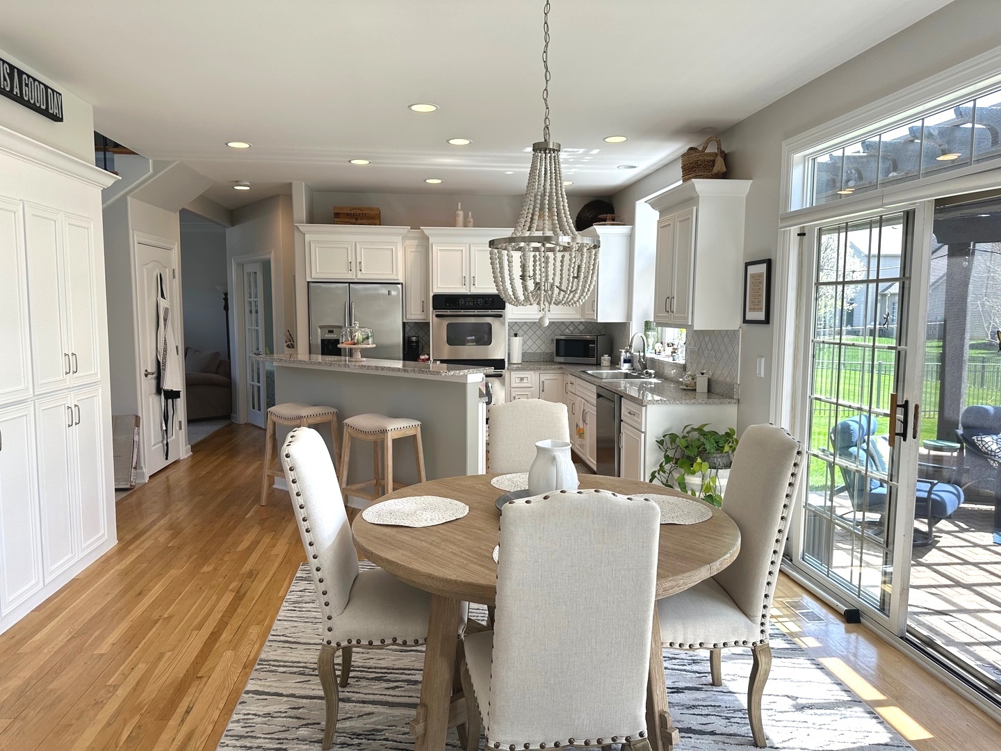 2212 Spartina Road Naperville, IL 60564 - Photo 4 of 17 a dining room with stainless steel appliances kitchen island granite countertop a dining table chairs and view living room