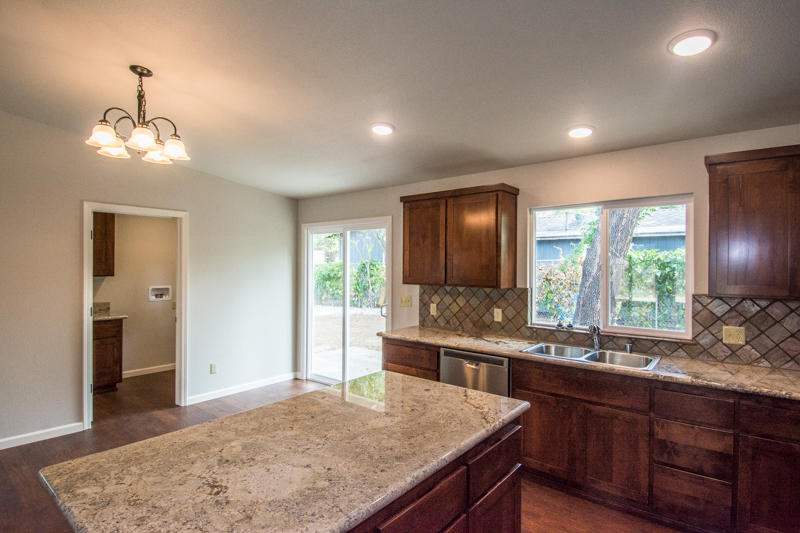 2765 Henderson Road Redding, CA 96002 - Photo 11 of 33 a view of kitchen island a sink and living room