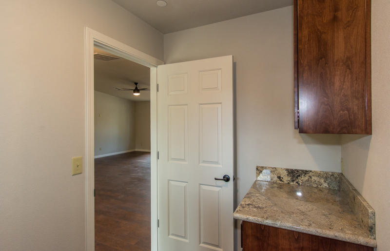 2765 Henderson Road Redding, CA 96002 - Photo 20 of 33 a kitchen with granite countertop cabinets and refrigerator