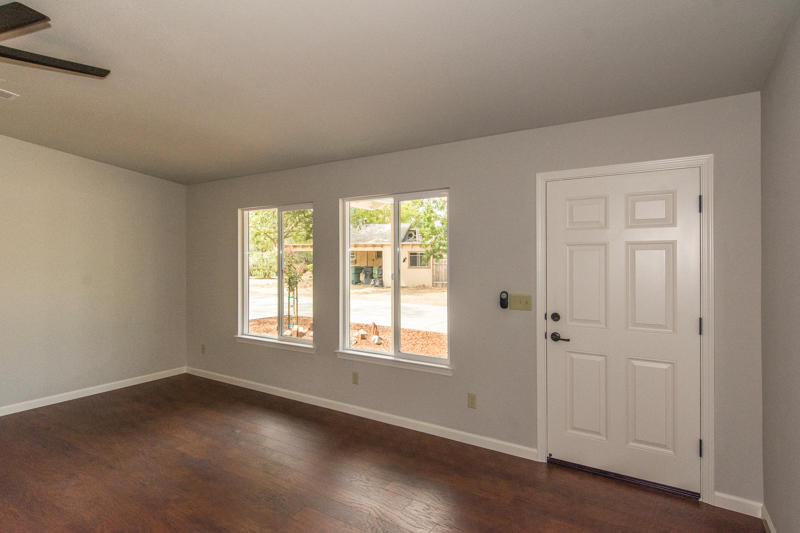 2765 Henderson Road Redding, CA 96002 - Photo 5 of 33 a view of an empty room with wooden floor and a window