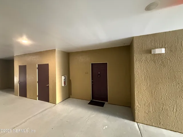 a view of an empty room with bathroom