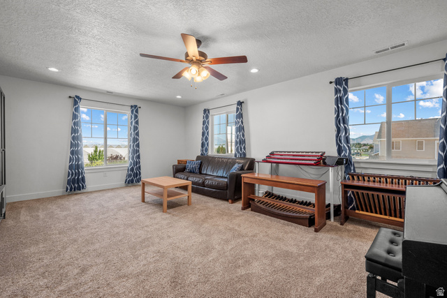 1693 North Center Point Lane Salem, UT 84653 - Photo 18 of 26 Carpeted room featuring multiple windows with patterned drapes, a ceiling fan with integrated lighting, and recessed lighting