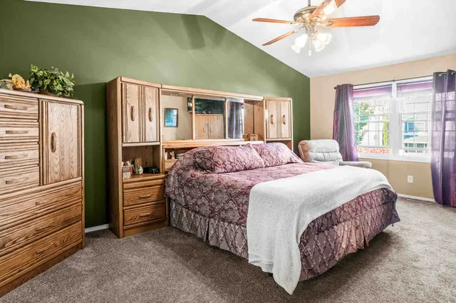 a bedroom with a bed dresser and a window