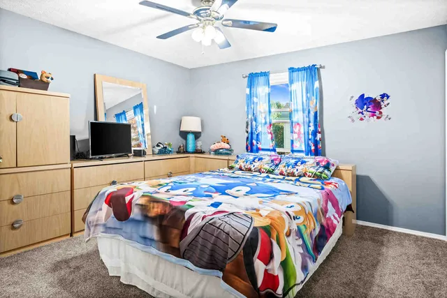 a bedroom with bed and flat screen tv