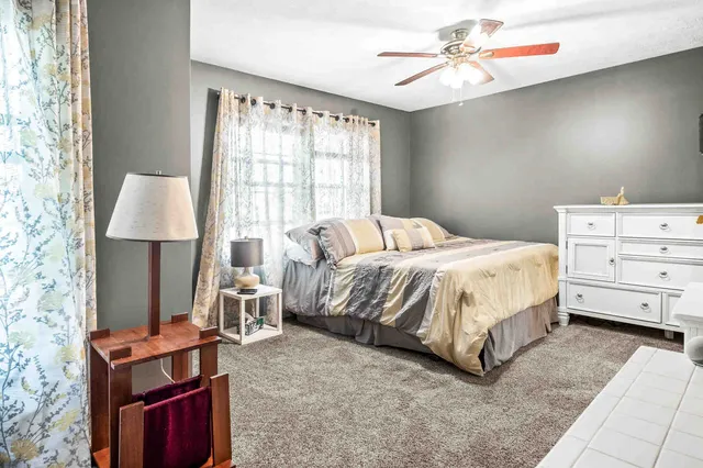 a bedroom with a bed and a fireplace