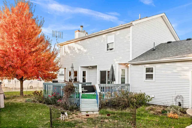 a view of backyard of house with green space