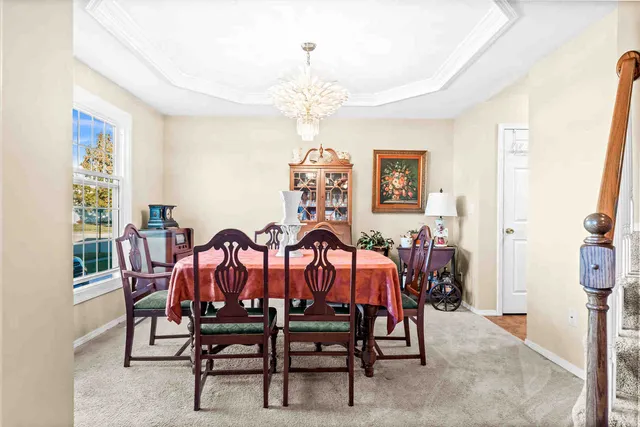 a view of a dining room with furniture and chandelier