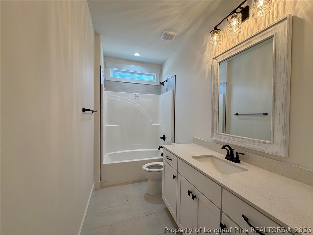 1788 Alderman Mill Road Dunn, NC 28334 - Photo 12 of 14 a bathroom with a double vanity sink toilet mirror and shower