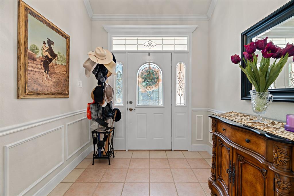 72 Crown Road Willow Park, TX 76087 - Photo 6 of 40 a kitchen with a stove and a painting on the wall