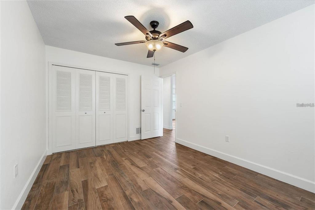8323 Banyan Boulevard Orlando, FL 32819 - Photo 13 of 20 a view of an empty room with wooden floor