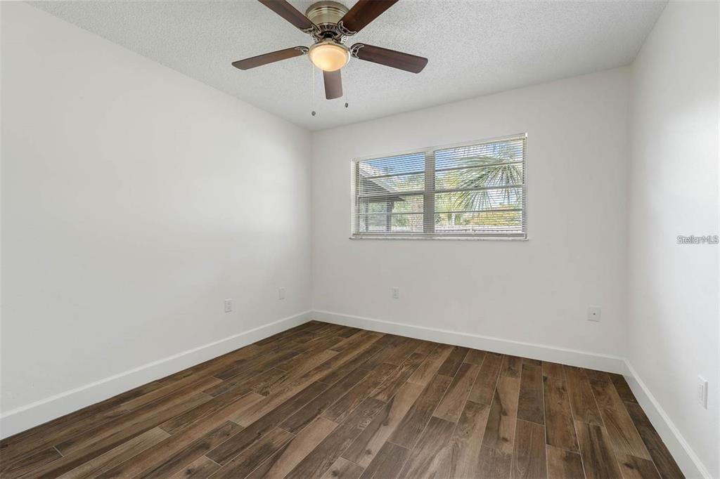 8323 Banyan Boulevard Orlando, FL 32819 - Photo 14 of 20 an empty room with a window and a ceiling fan