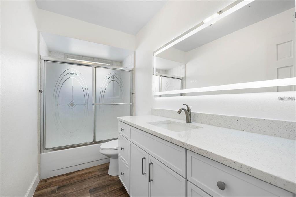 8323 Banyan Boulevard Orlando, FL 32819 - Photo 15 of 20 a bathroom with a granite countertop sink toilet and shower