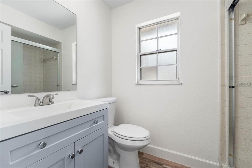 8323 Banyan Boulevard Orlando, FL 32819 - Photo 16 of 20 a bathroom with a toilet sink vanity and mirror