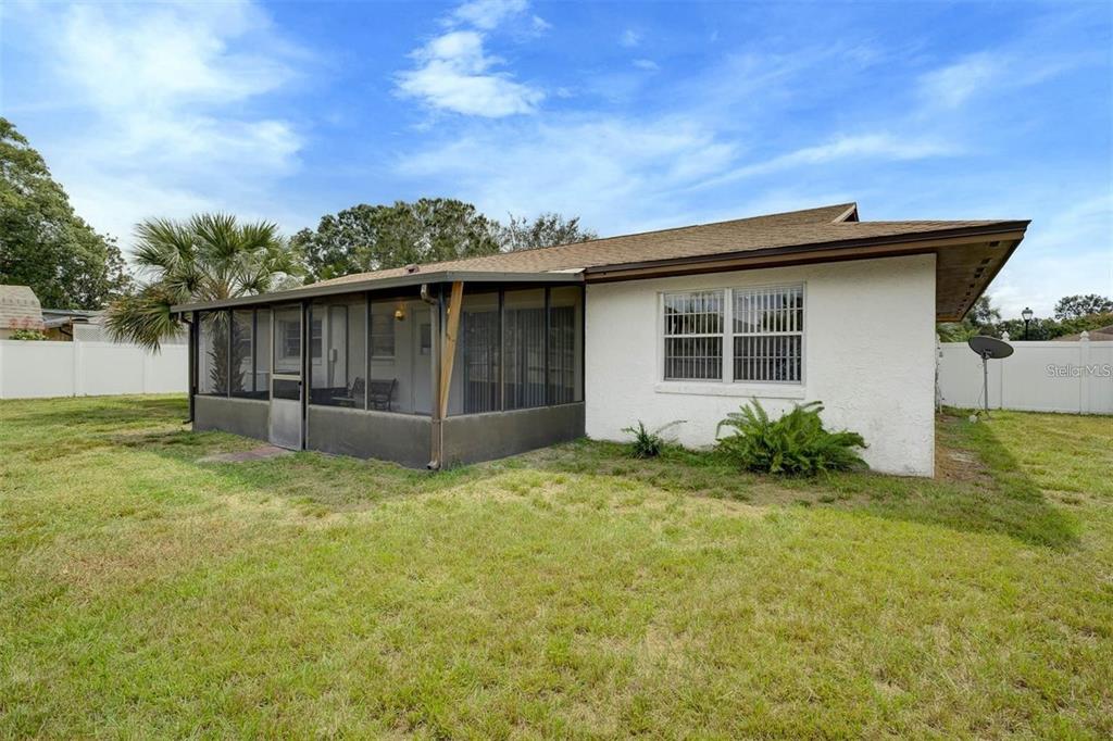 8323 Banyan Boulevard Orlando, FL 32819 - Photo 18 of 20 a backyard of a house with plants and wooden fence