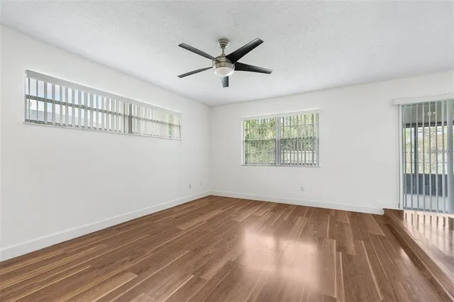 wooden floor in an empty room with a window
