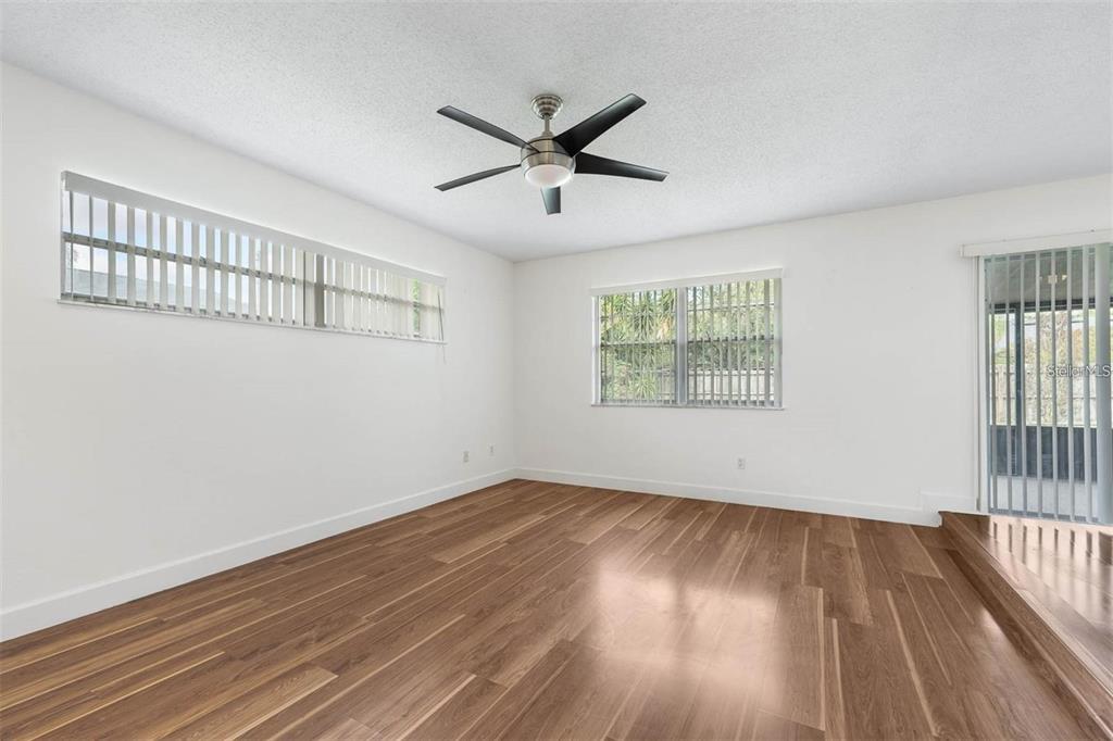 8323 Banyan Boulevard Orlando, FL 32819 - Photo 8 of 20 wooden floor in an empty room with a window