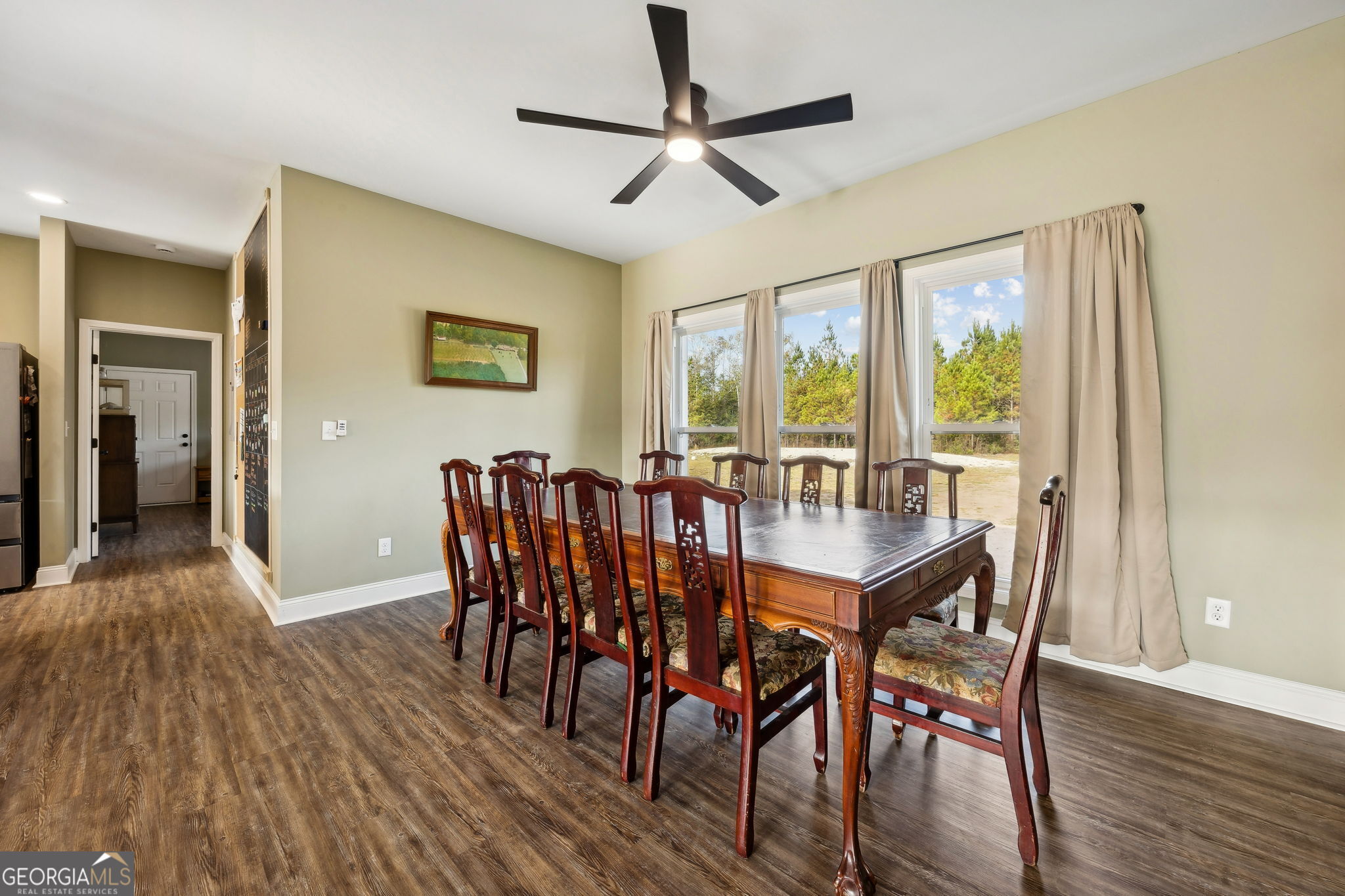 691 Oak Well Road Kingsland, GA 31548 - Photo 15 of 82 a view of a dining room with furniture window and wooden floor