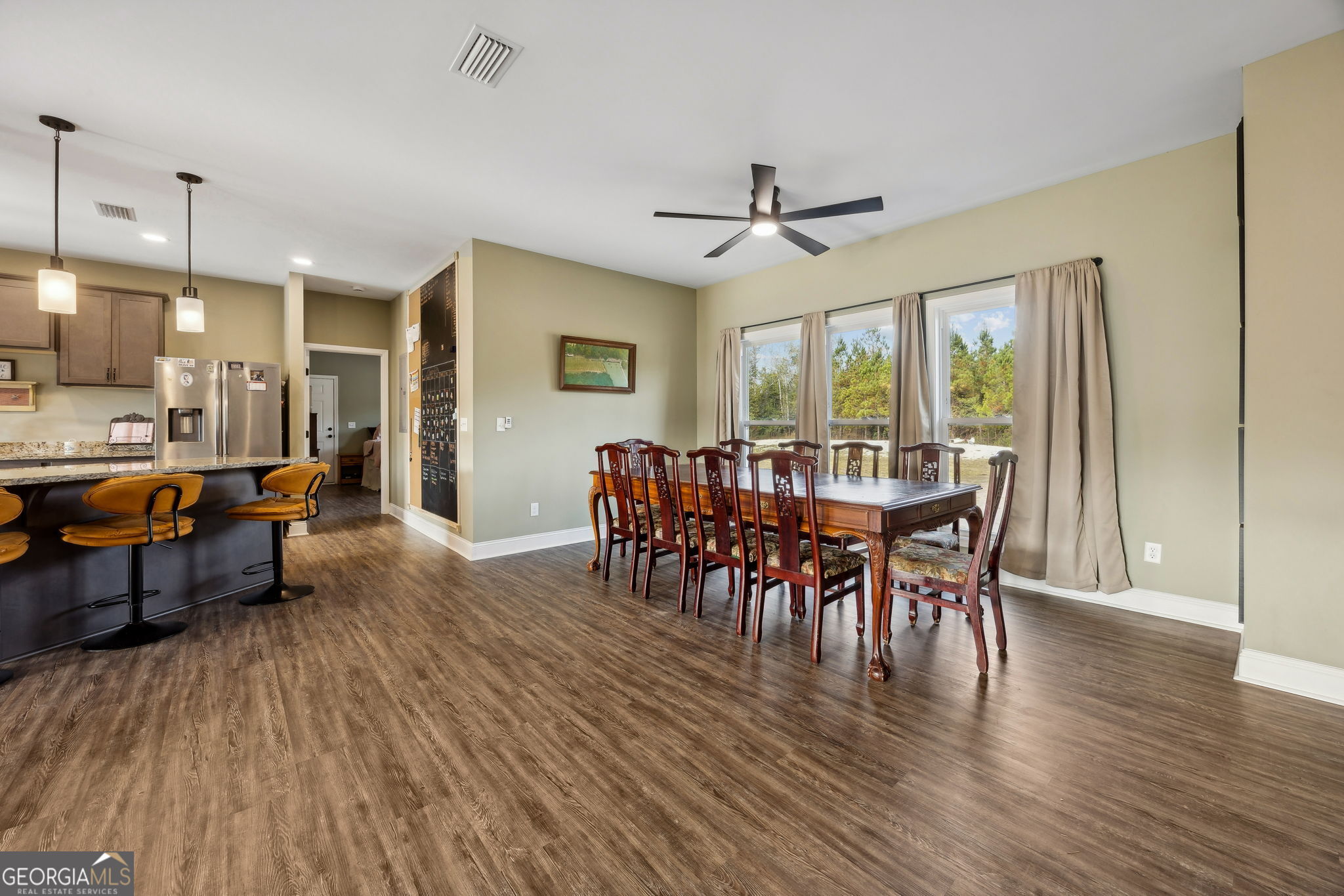 691 Oak Well Road Kingsland, GA 31548 - Photo 16 of 82 a view of a a dining room with furniture window and wooden floor