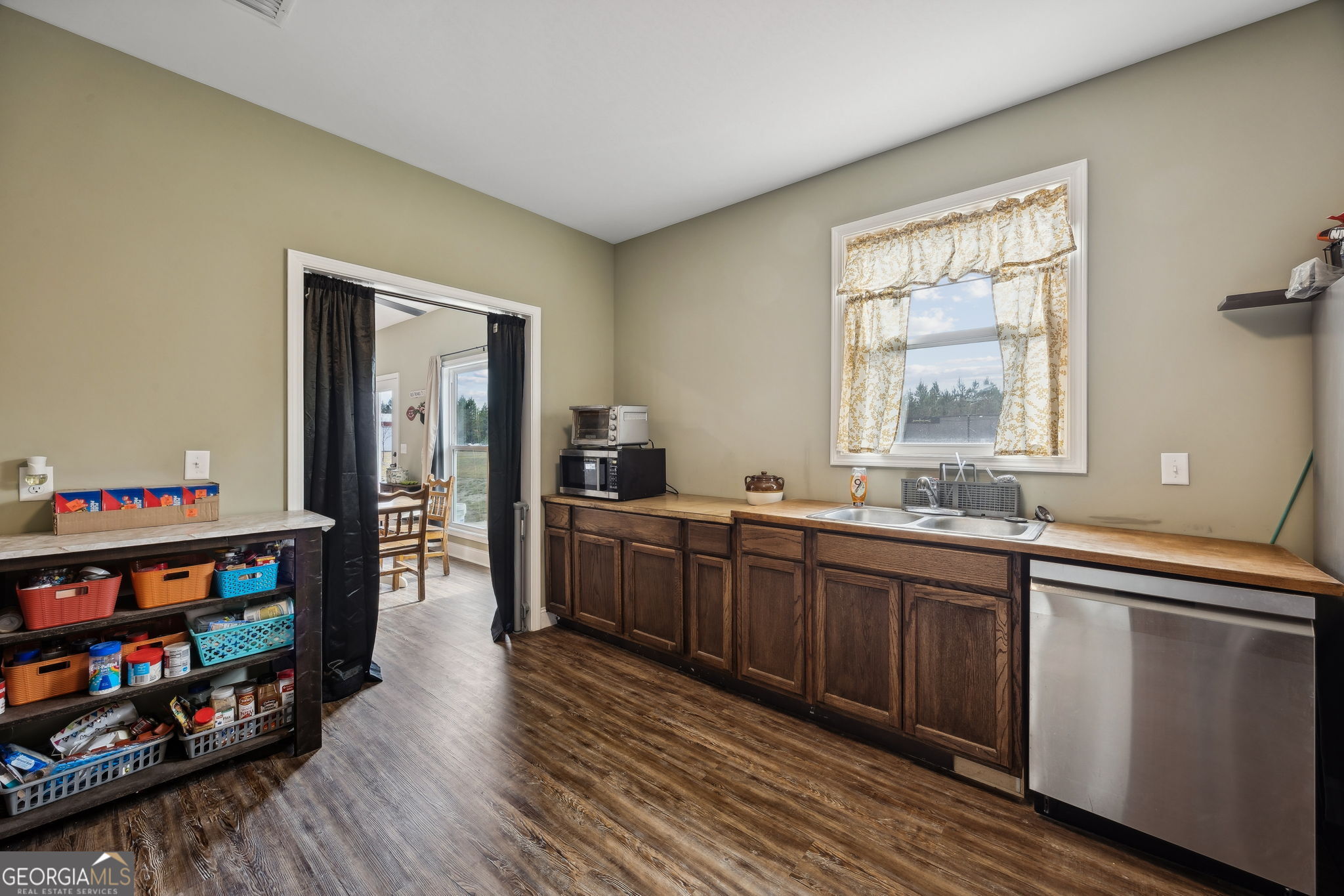691 Oak Well Road Kingsland, GA 31548 - Photo 29 of 82 a kitchen with stainless steel appliances granite countertop a sink and wooden cabinets