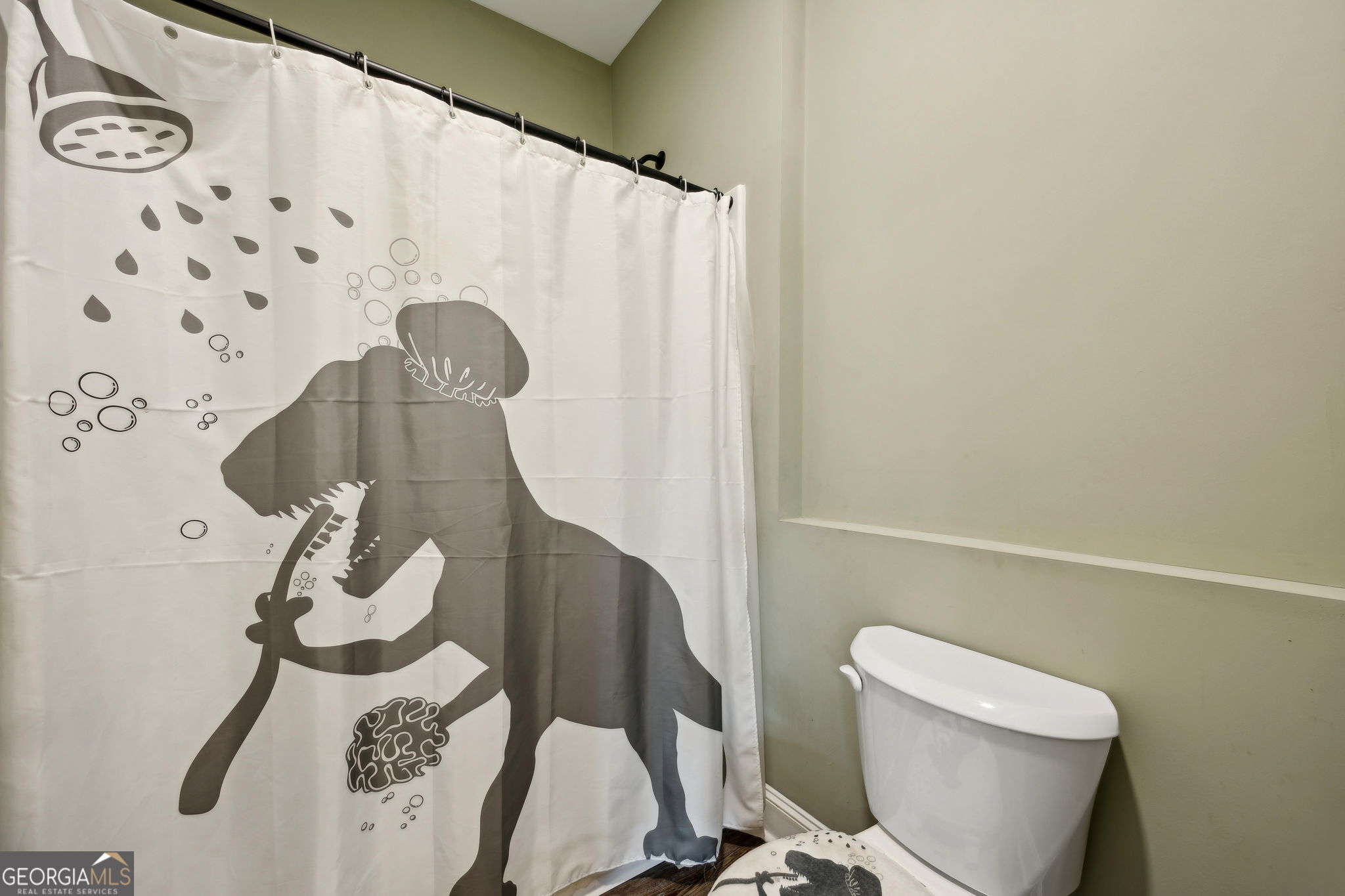 691 Oak Well Road Kingsland, GA 31548 - Photo 52 of 82 a white toilet sitting next to a shower curtain