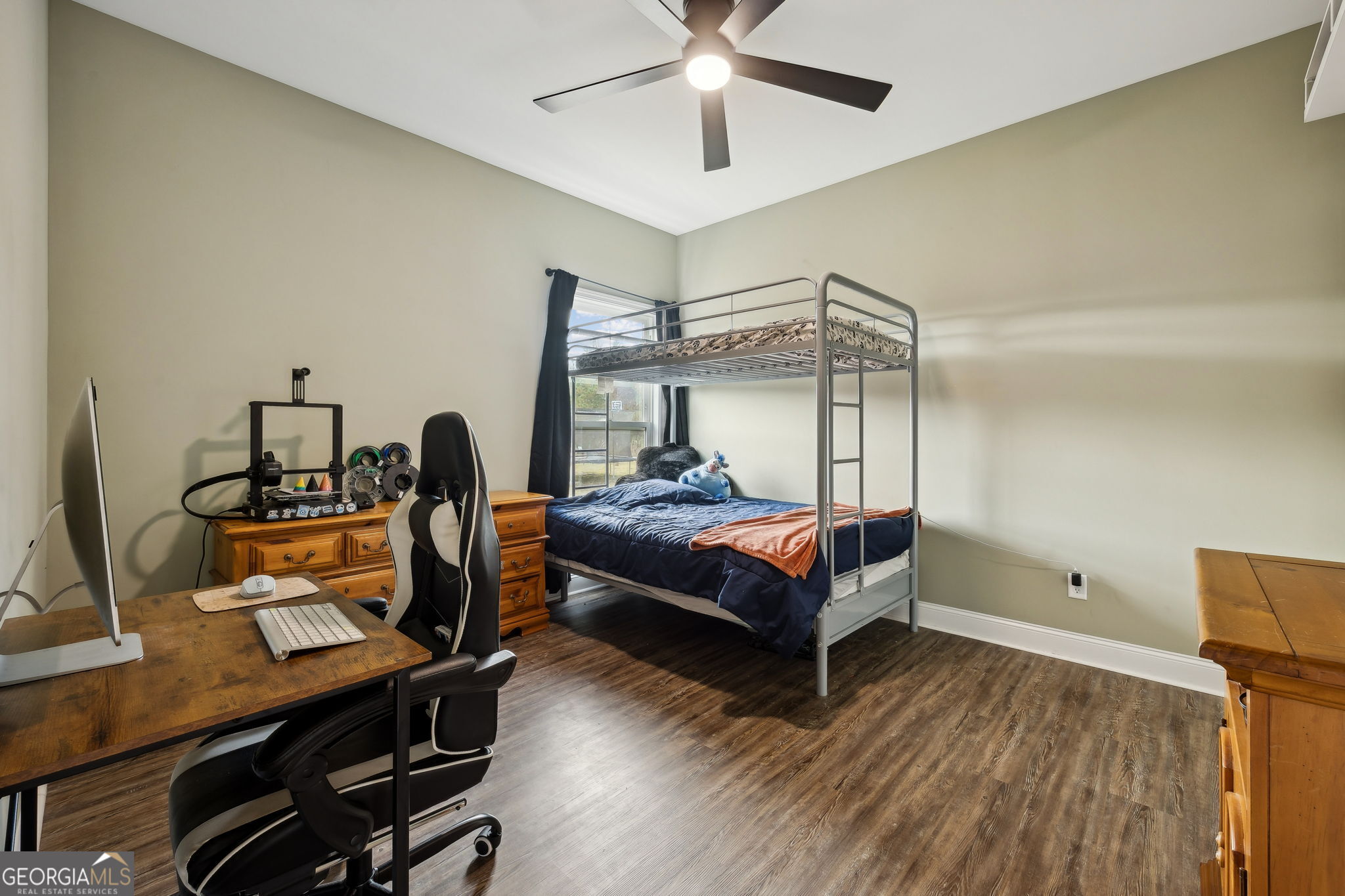 691 Oak Well Road Kingsland, GA 31548 - Photo 54 of 82 a bedroom with a bed a desk and chair with wooden floor