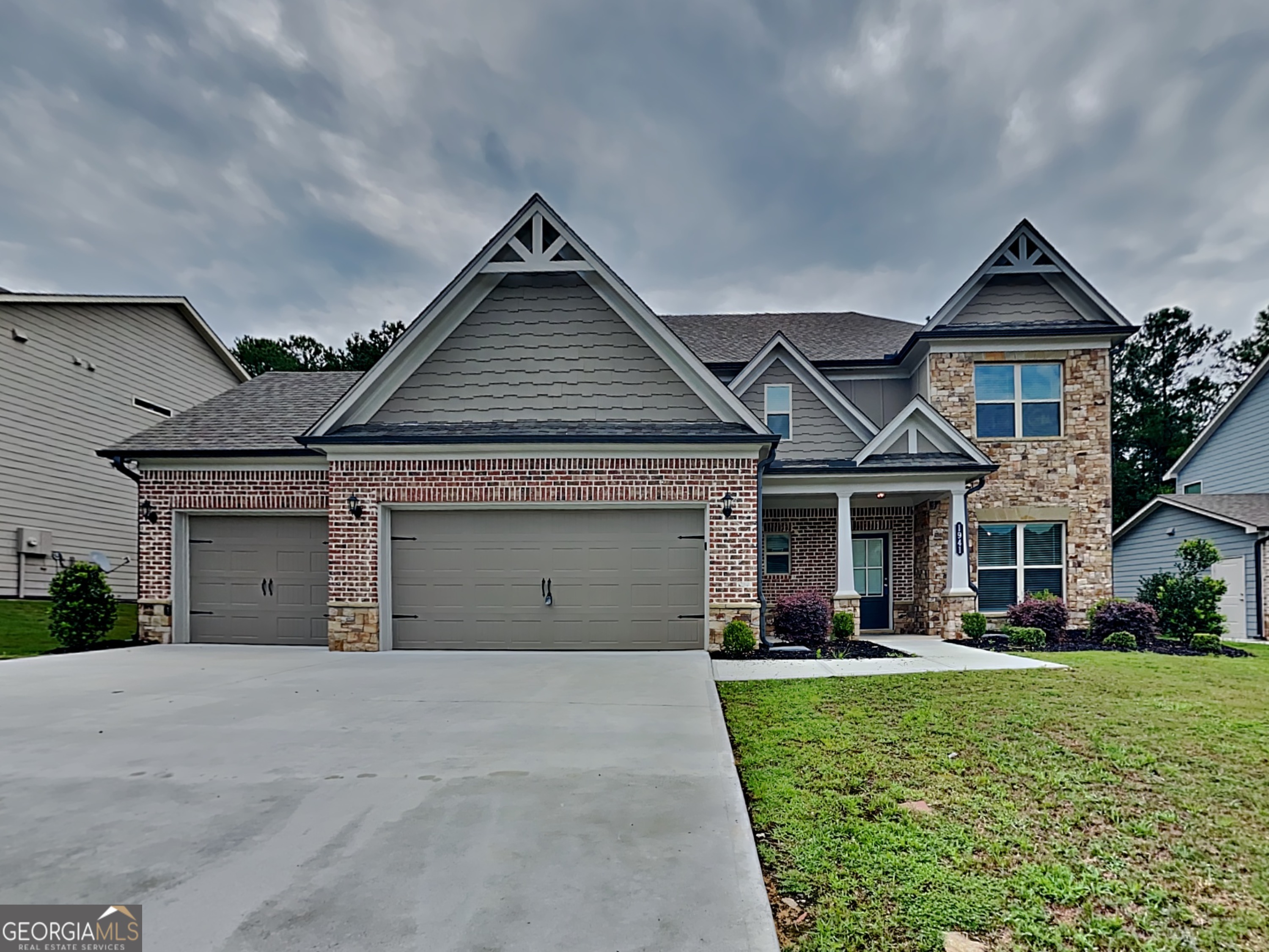 1941 Cobblefield Circle Dacula, GA 30019 - Photo 1 of 1 a front view of a house with a yard and garage