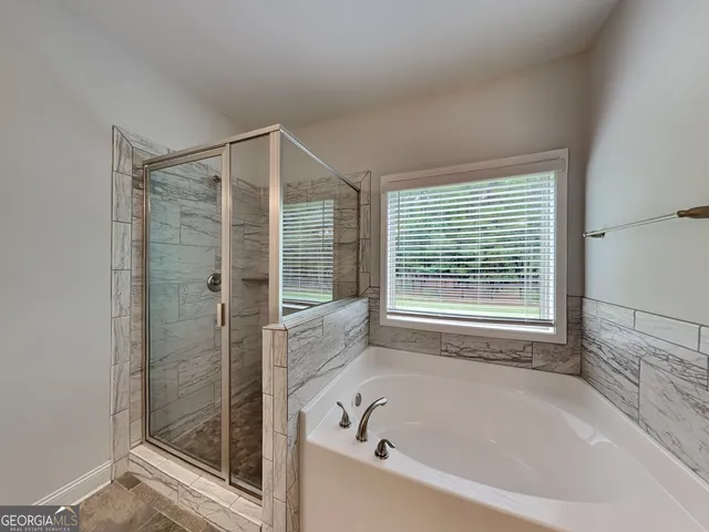 a bathroom with a bathtub and shower