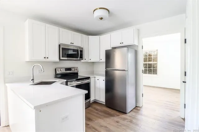 a kitchen with a refrigerator sink and microwave