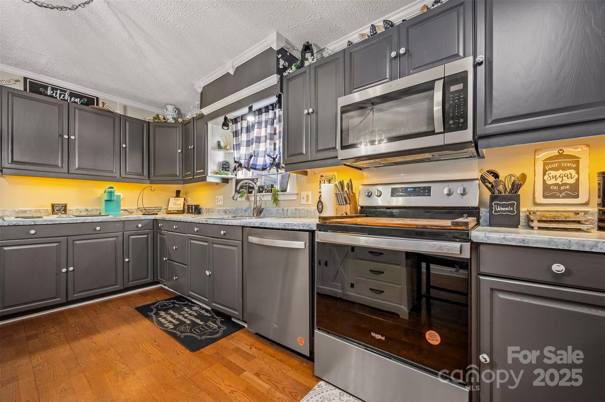 334 Bridge Road Ellenboro, NC 28040 - Photo 19 of 48 a kitchen with stainless steel appliances kitchen island granite countertop a stove a sink and a microwave