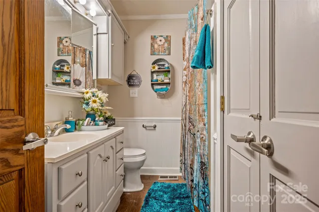 a bathroom with a sink mirror vanity and toilet