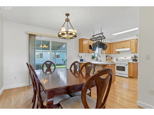 a view of a dining room with furniture and chandelier