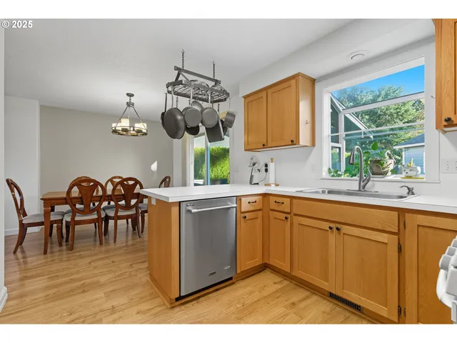 a kitchen with a sink dining table and chairs