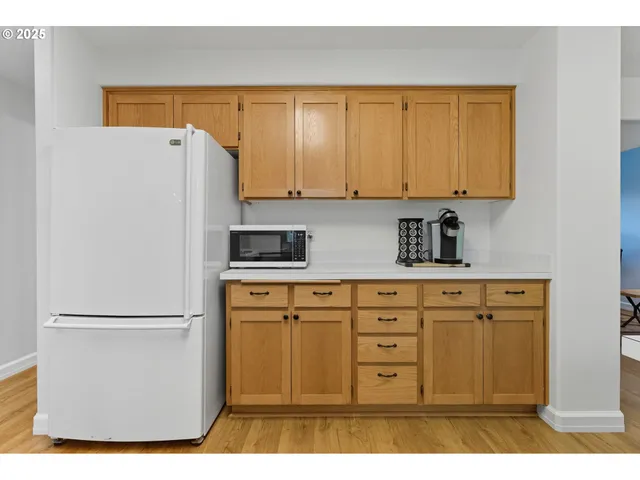 a kitchen with stainless steel appliances a refrigerator sink and cabinets