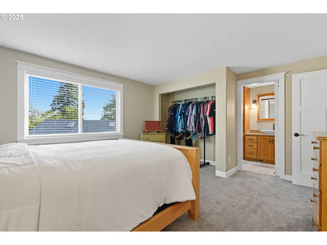 a bedroom with a bed and a large mirror