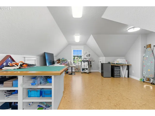 a living room with furniture a flat screen tv and kitchen view