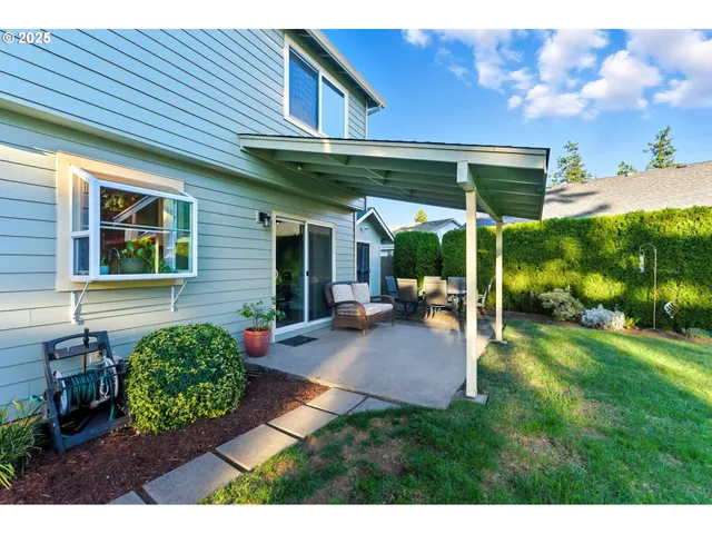 a view of a patio with table and chairs under an umbrella